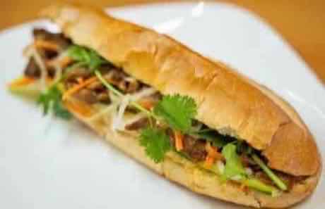 Grilled beef banh mi on a crusty baguette