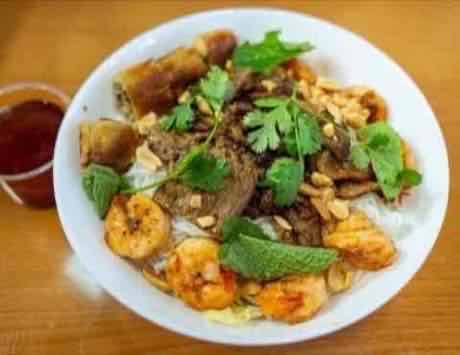 Vermicelli bowl with grilled beef, shrimp, egg roll, peanuts and fresh mint