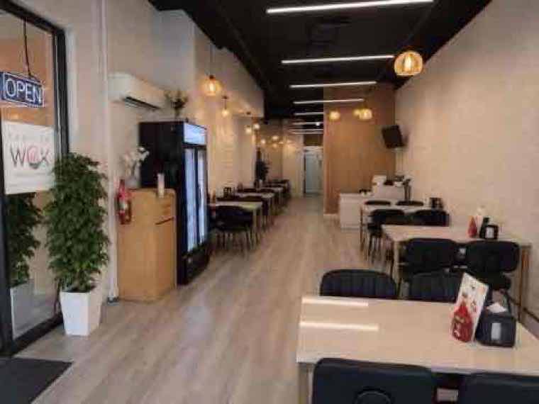 Freshly remodeled Fashion Wok dining room with modern seating and pendant lighting