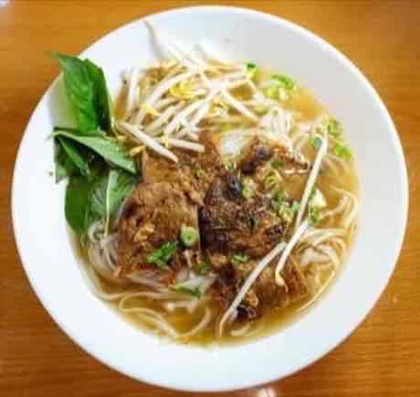Noodle soup with tender braised beef, bean sprouts and Thai basil