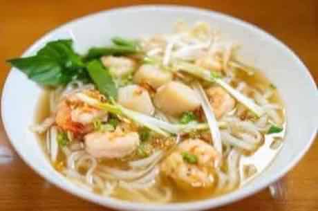 Bowl of seafood rice noodle soup with shrimp and scallops