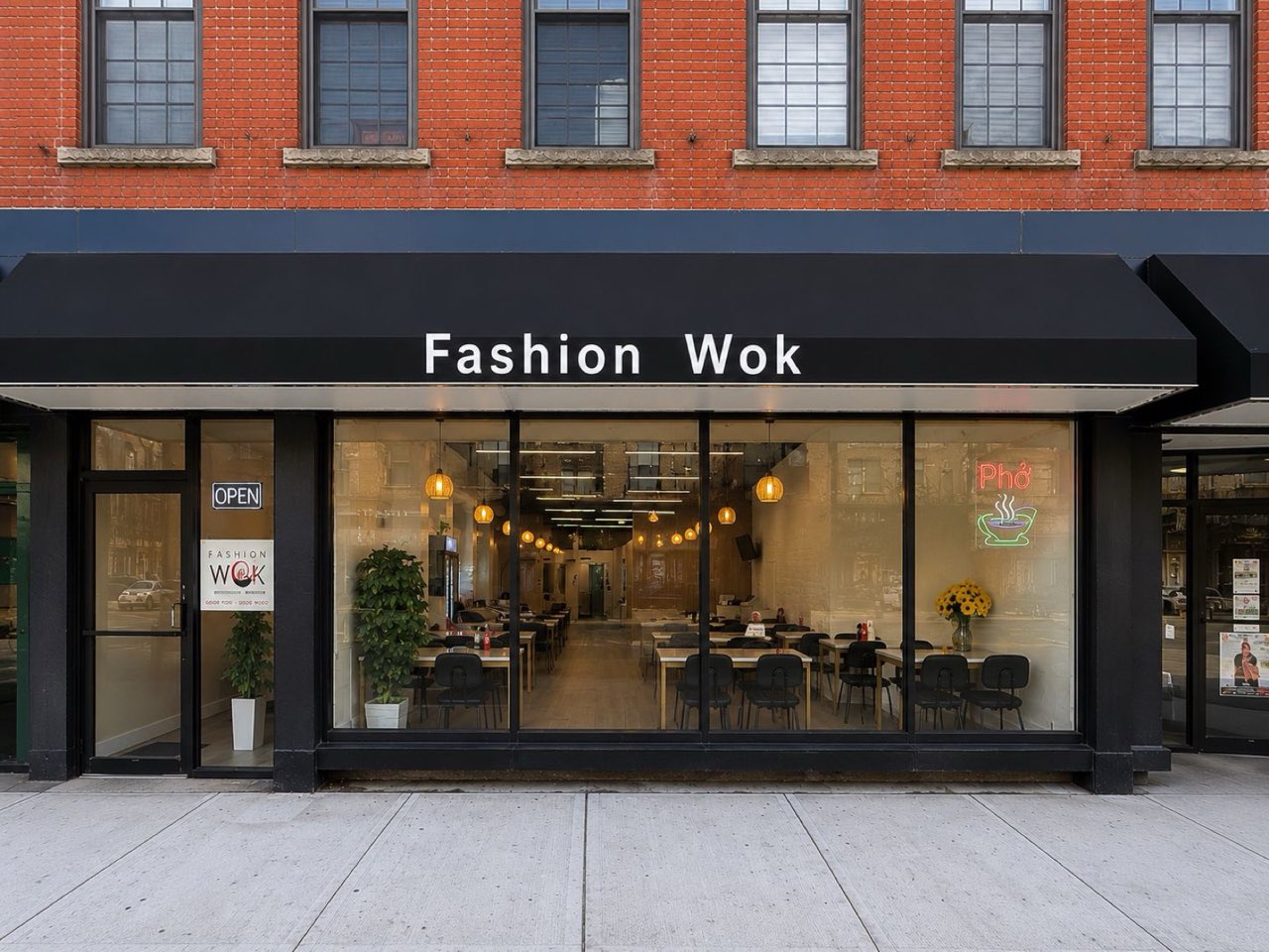 Newly renovated Fashion Wok storefront with black awning and large windows in Middletown, NY